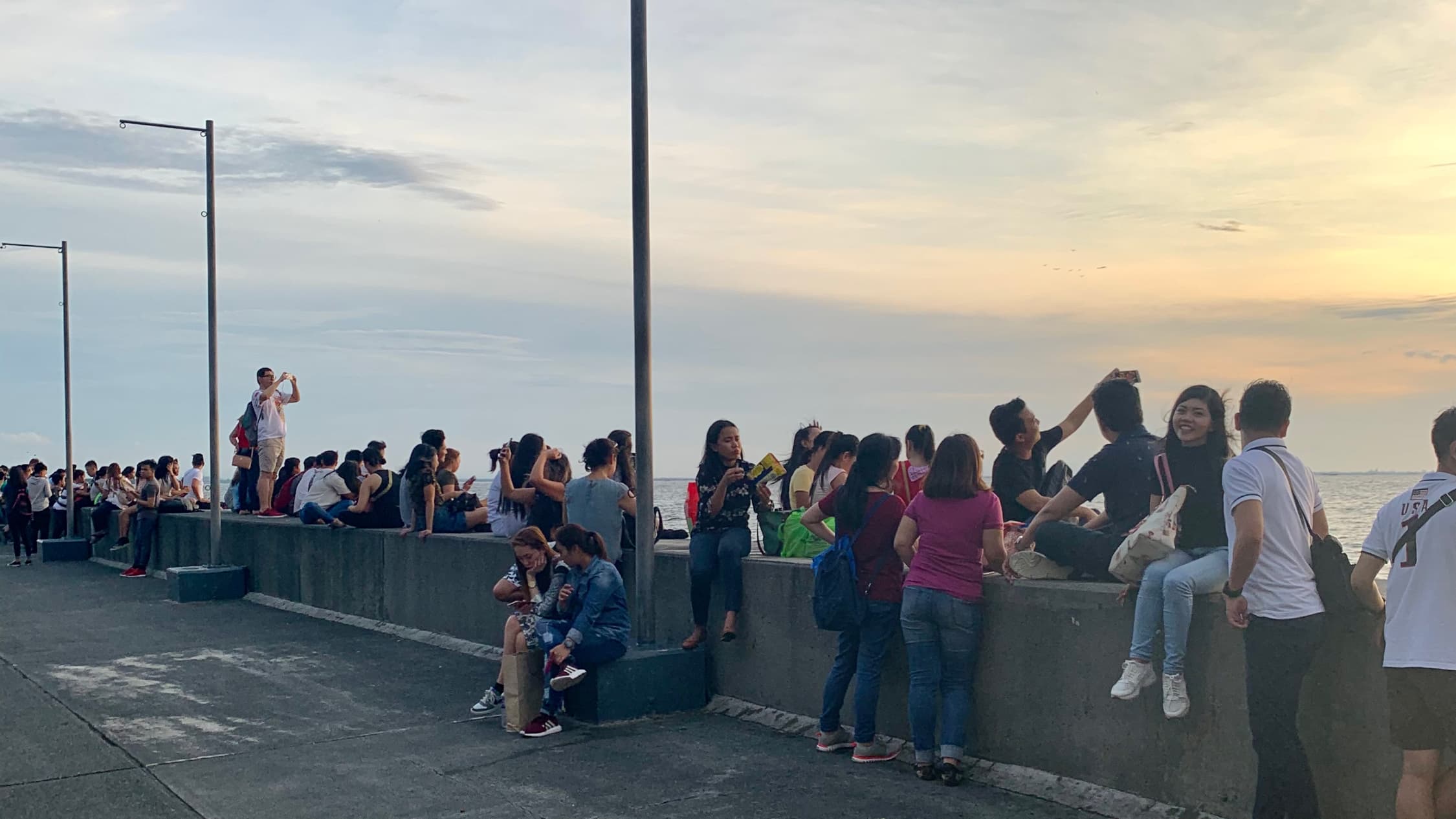 Filipinos at Mall of Asia Seaside, Manila bay, Philippines